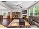 Spacious living room with a fireplace, ceiling fan, hardwood floors and large windows at 428 Morgan Ridge Rd, Holly Springs, NC 27540