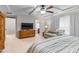 Main bedroom featuring tray ceiling, sitting area, TV, and ensuite bathroom at 428 Morgan Ridge Rd, Holly Springs, NC 27540