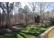 Scenic backyard with a well-maintained lawn and mature trees creating a tranquil environment at 4332 Blossom Hill Ct, Raleigh, NC 27613