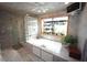 Bright bathroom with a large garden tub, glass block partition and tiled walls at 4332 Blossom Hill Ct, Raleigh, NC 27613