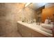 Well-lit bathroom featuring double sinks, granite countertops, and tiled walls at 4332 Blossom Hill Ct, Raleigh, NC 27613