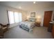 Bright, carpeted bedroom with ample natural light and comfortable decor at 4332 Blossom Hill Ct, Raleigh, NC 27613
