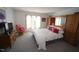 Cozy bedroom featuring a comfortable bed, storage unit, and natural light at 4332 Blossom Hill Ct, Raleigh, NC 27613