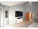 Modern primary bedroom featuring a vaulted ceiling, large TV, and a fireplace at 4332 Blossom Hill Ct, Raleigh, NC 27613