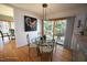 Cozy dining area with a glass table, patio doors, and a colorful piece of art at 4332 Blossom Hill Ct, Raleigh, NC 27613