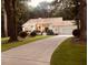 Picturesque one-story home featuring a driveway and lush greenery, framed by mature trees at 4332 Blossom Hill Ct, Raleigh, NC 27613