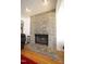 Cozy living room featuring a stone fireplace with a raised hearth and hardwood floors at 4332 Blossom Hill Ct, Raleigh, NC 27613