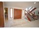 Spacious foyer with tile flooring, a large double-door entrance, and a staircase at 4332 Blossom Hill Ct, Raleigh, NC 27613