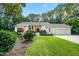 Charming single-story home with manicured lawn, mature trees, and attached garage at 4332 Blossom Hill Ct, Raleigh, NC 27613