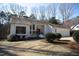 Beautiful single-story home with manicured lawn and mature trees and an attached garage at 4332 Blossom Hill Ct, Raleigh, NC 27613