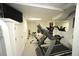 Bright home gym with carpet and mirrored wall is furnished with modern exercise equipment at 4332 Blossom Hill Ct, Raleigh, NC 27613