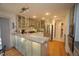 Modern kitchen with granite countertops, stainless steel appliances, and frosted glass cabinets at 4332 Blossom Hill Ct, Raleigh, NC 27613