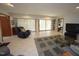 Comfortable living room features a leather recliner, tile flooring, and sliding glass doors to the exterior at 4332 Blossom Hill Ct, Raleigh, NC 27613