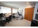 A bright office space with two windows, a desk and chair and an inversion table at 4332 Blossom Hill Ct, Raleigh, NC 27613