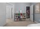 This bedroom boasts an open closet and a custom bookshelf filled with books and toys at 4711 Marena Pl, Durham, NC 27707