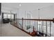 Second floor hallway with views of the living room below showcases hardwood railing with iron spindles at 4711 Marena Pl, Durham, NC 27707