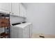 Laundry room featuring a washer, dryer, and storage cabinets at 4711 Marena Pl, Durham, NC 27707