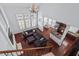 Open concept living space featuring a large gray sectional, hardwood floors, and a kitchen with granite countertops at 4711 Marena Pl, Durham, NC 27707