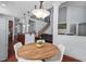 Open-concept living space with a view of the staircase and a large window for natural light at 4711 Marena Pl, Durham, NC 27707