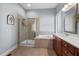 Bathroom with a large soaking tub, tiled shower, and double vanity with ample counter space at 4711 Marena Pl, Durham, NC 27707
