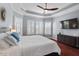 Main bedroom with a king-size bed, a ceiling fan, and natural light from the windows at 4711 Marena Pl, Durham, NC 27707