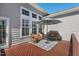 An outdoor patio area is decorated with stylish furniture and a sun umbrella at 4711 Marena Pl, Durham, NC 27707