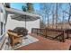 An outdoor patio features wood flooring, stylish furniture, and a sun umbrella at 4711 Marena Pl, Durham, NC 27707