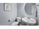 Powder room with a pedestal sink, toilet, and a decorative mirror at 4711 Marena Pl, Durham, NC 27707