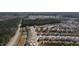 Wide aerial shot of a community featuring numerous homes surrounded by lush greenery and roadways at 5 Misty Grove Trl, Franklinton, NC 27525