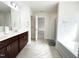 Bathroom with double sink vanity, tile floors, soaking tub and glass enclosed shower at 5 Misty Grove Trl, Franklinton, NC 27525