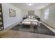 Comfortable bedroom with carpet, neutral walls, a large bed, and bench at 5 Misty Grove Trl, Franklinton, NC 27525