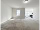 Spacious bonus room with a window and neutral carpet ready for customization at 5 Misty Grove Trl, Franklinton, NC 27525