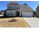 Charming two-story home with a well-manicured lawn and attached two car garage at 5 Misty Grove Trl, Franklinton, NC 27525