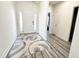 Welcoming foyer with stylish rug, wood-look floors, and natural light at 5 Misty Grove Trl, Franklinton, NC 27525