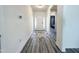 Bright foyer with wood-look floors, white walls, and an elegant area rug at 5 Misty Grove Trl, Franklinton, NC 27525