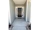 Inviting front door entrance with sidelights and decorative 'hello' decal at 5 Misty Grove Trl, Franklinton, NC 27525