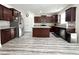 Open kitchen featuring stainless appliances, island, and sleek, dark cabinetry at 5 Misty Grove Trl, Franklinton, NC 27525