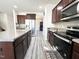 Modern kitchen featuring stainless steel appliances, dark cabinets, and a stylish backsplash at 5 Misty Grove Trl, Franklinton, NC 27525