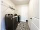 Efficient laundry room with modern washer and dryer, and a wire shelf for storage at 5 Misty Grove Trl, Franklinton, NC 27525