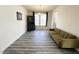 Bright living room featuring modern floors, a sofa, and ample natural light at 5 Misty Grove Trl, Franklinton, NC 27525