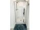 A view of the glass enclosed shower featuring a chrome shower head and built in shelves at 5 Misty Grove Trl, Franklinton, NC 27525