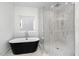 Modern bathroom featuring a standalone tub and a glass-enclosed shower at 509 Colleton Rd, Raleigh, NC 27610