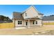 Rear exterior view of a two-story home with a covered patio and a spacious, partially fenced yard at 51 Blackberry Ln, Benson, NC 27504