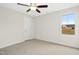 Comfortable bedroom with neutral carpet, ceiling fan, and a window with a view to the outdoors at 51 Blackberry Ln, Benson, NC 27504