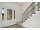 Welcoming entryway featuring a decorative glass door, wood floors, and an elegant staircase with iron spindles at 51 Blackberry Ln, Benson, NC 27504