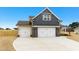Inviting home with a three car garage, with a modern design, stone accents, and a pristine driveway at 51 Blackberry Ln, Benson, NC 27504