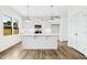 Bright, spacious kitchen with white cabinets, stainless steel appliances, a large island and ample counter space at 51 Blackberry Ln, Benson, NC 27504