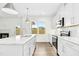 Modern kitchen with white cabinetry, stainless steel appliances, marble countertops, and an island at 51 Blackberry Ln, Benson, NC 27504