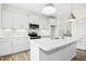 Contemporary kitchen with white cabinetry, stainless steel appliances, a marble island, and sleek modern design at 51 Blackberry Ln, Benson, NC 27504