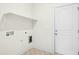 Laundry room with shelf and hookups, door, and decorative flooring at 51 Blackberry Ln, Benson, NC 27504